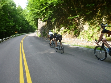 Riders descending winding road