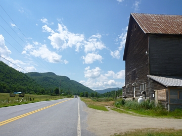 Scenic valley and large, unpainted barn