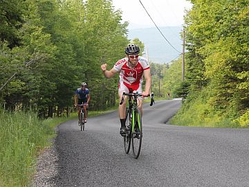 Cyclist approaching old barn